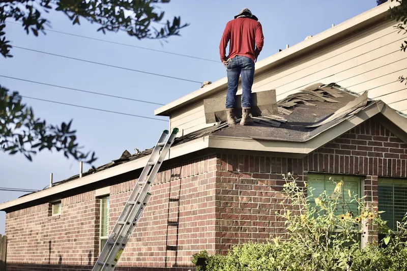 Professional roofer working on a residential roof in Fowlertown